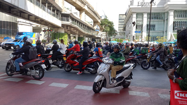 Motorbikes piling up at a red light, Bangkok, Thailand